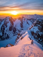 Runner ascending a rugged mountain trail at sunrise