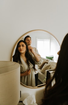 a man and woman taking a selfie in a mirror