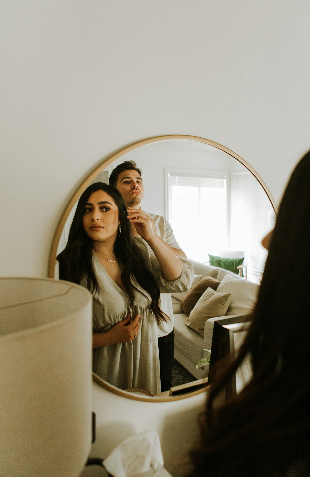 a man and woman taking a selfie in a mirror
