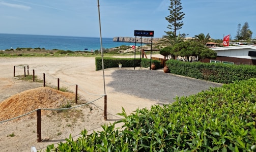 Commercial land plots with clear signage near a busy coastal road.