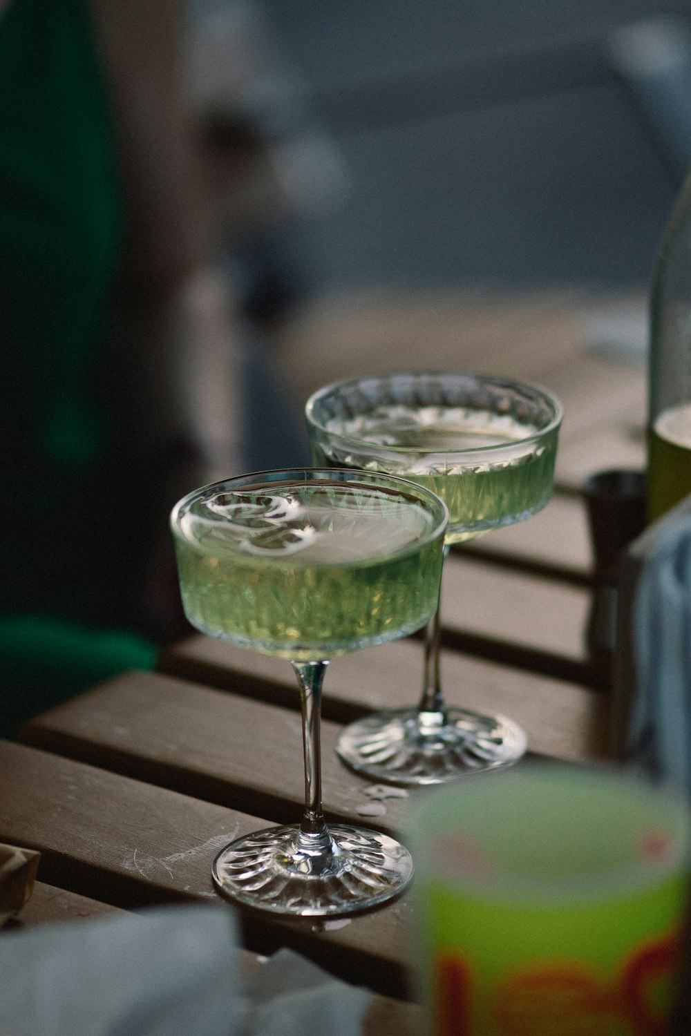 a couple of glasses with green liquid