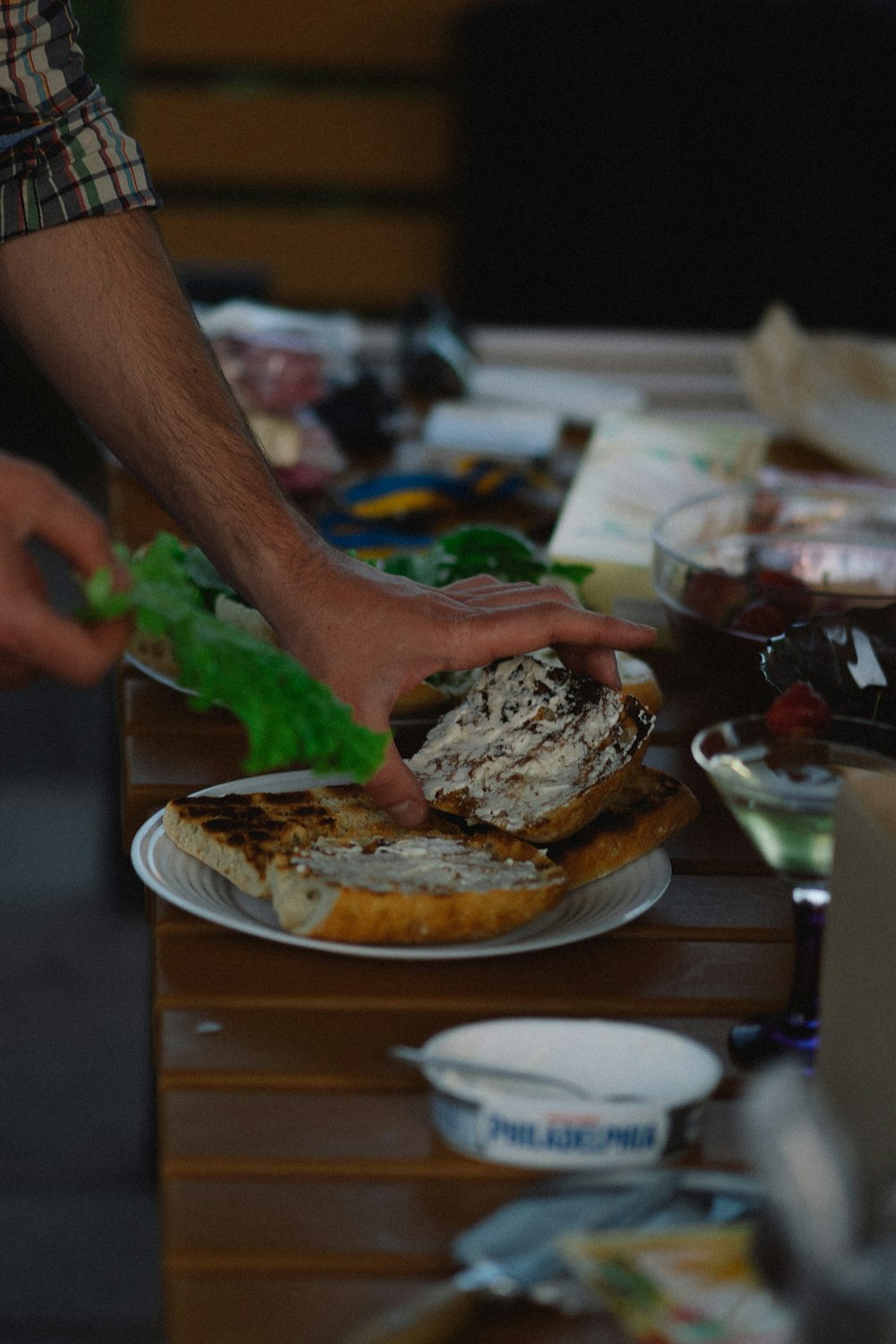 a person is cutting a sandwich