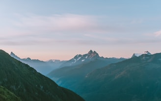 A breathtaking panoramic shot of snow-capped mountains at sunrise.