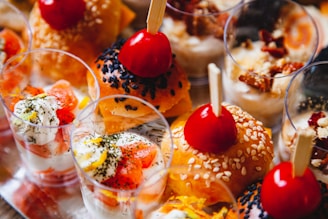 a group of glasses with food in them