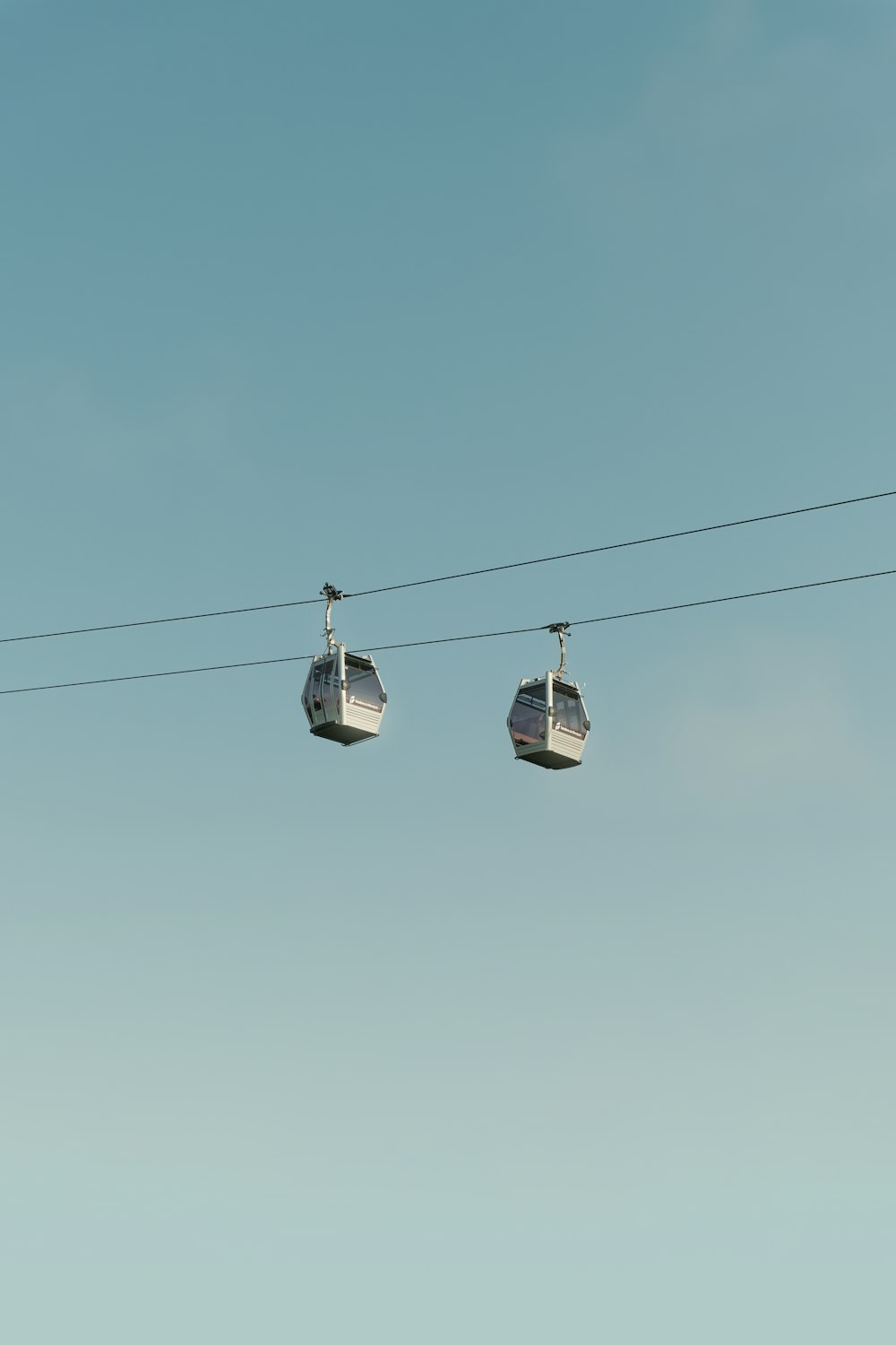 a pair of cars on a cable