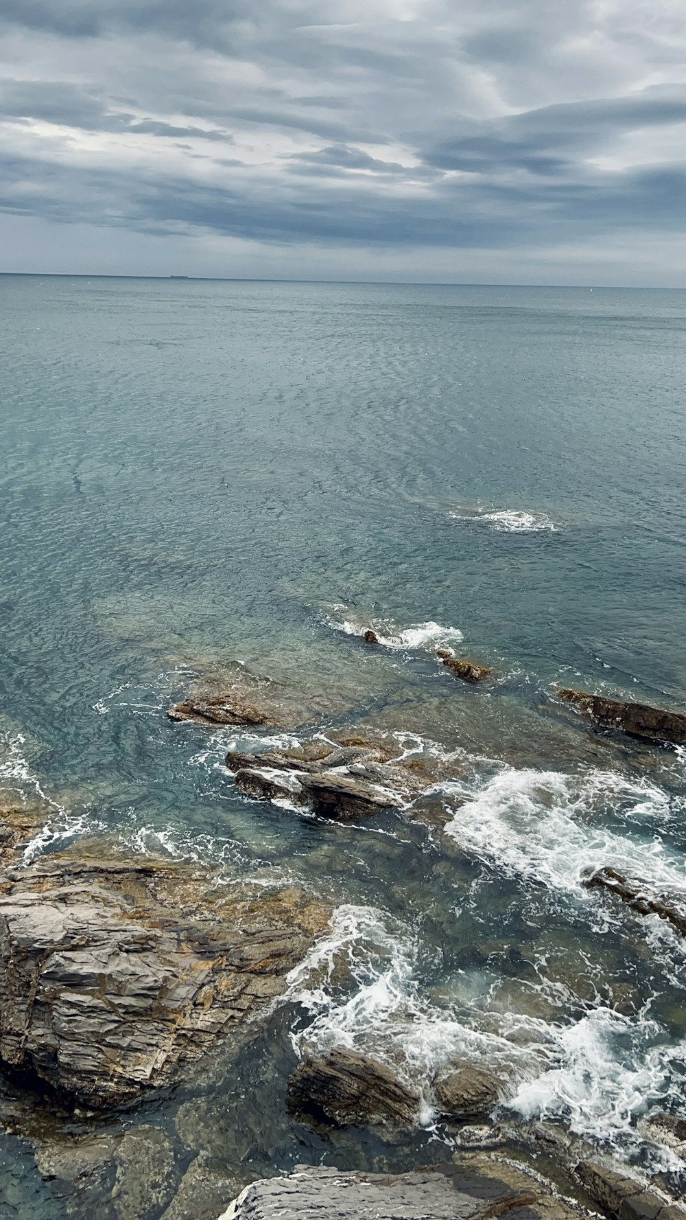 a rocky beach with waves crashing