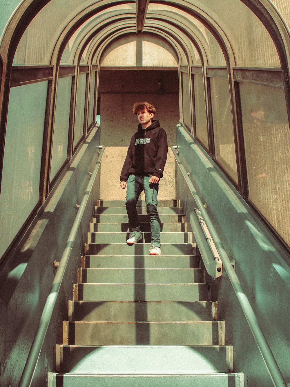 a boy standing on a set of stairs