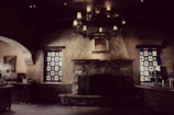 Rustic stone fireplace surrounded by comfortable seating and warm lighting.