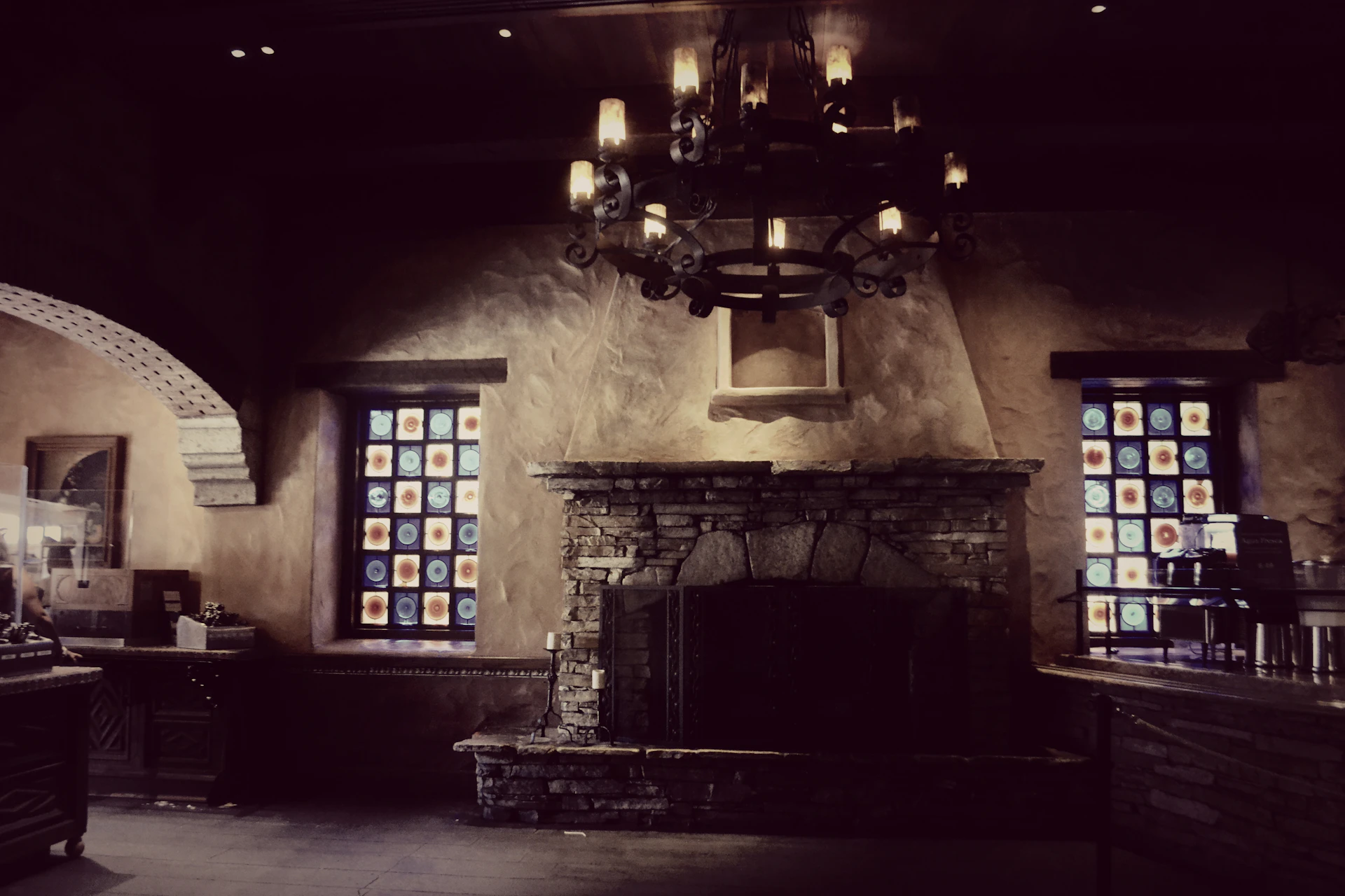 A warm, rustic interior shot showing the living area with a fireplace and soft lighting.
