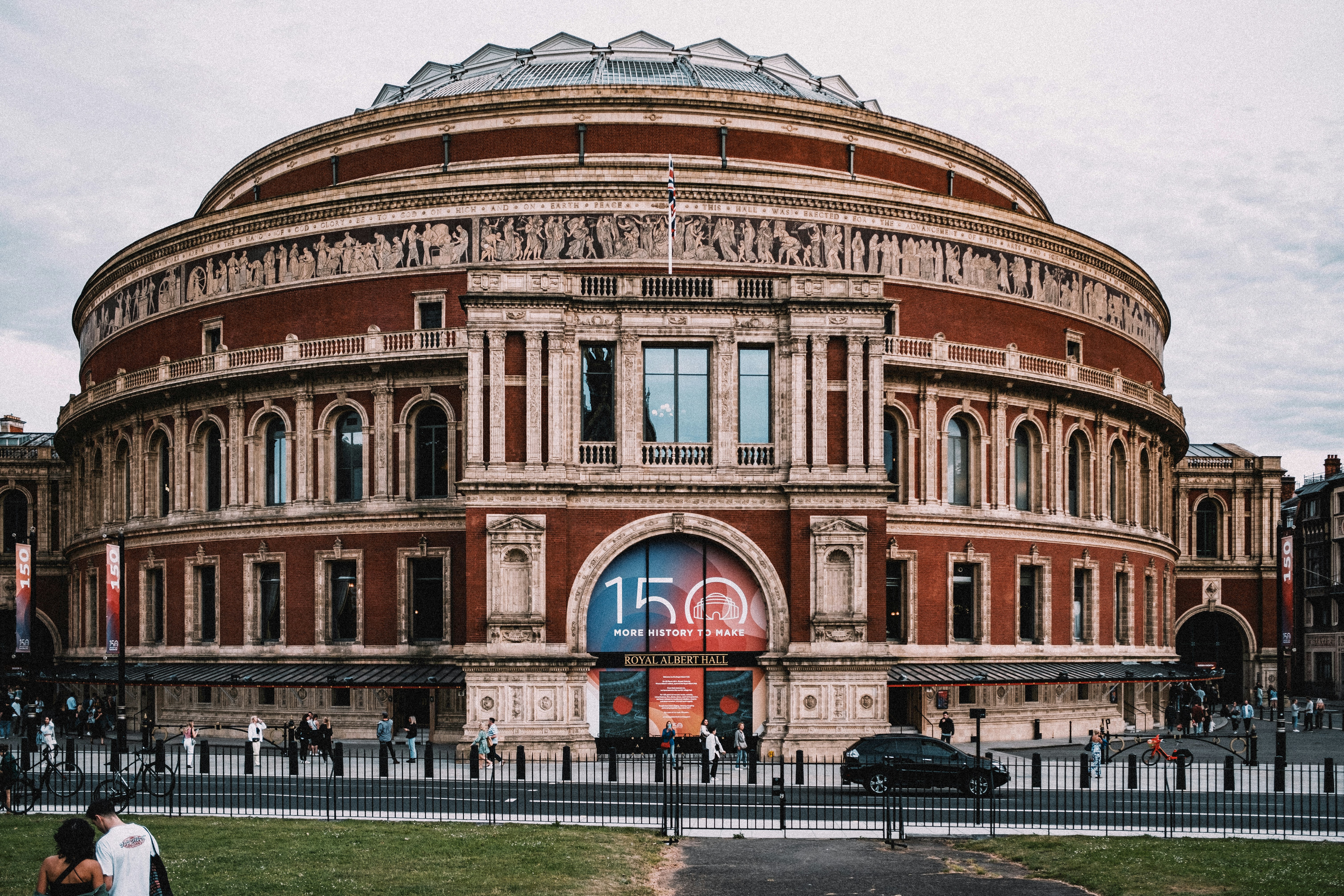 a large building with a large arched window with Royal Albert Hall in the background