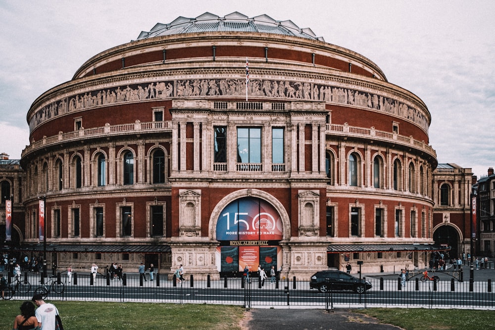 a large building with a large arched window with Royal Albert Hall in the background