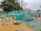 Children playing outside in a spacious, vibrant playground.