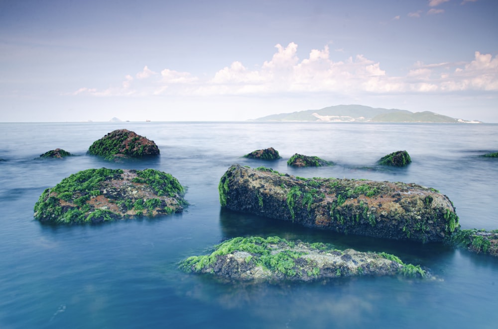 a group of islands in the ocean with Hundred Islands National Park in the background