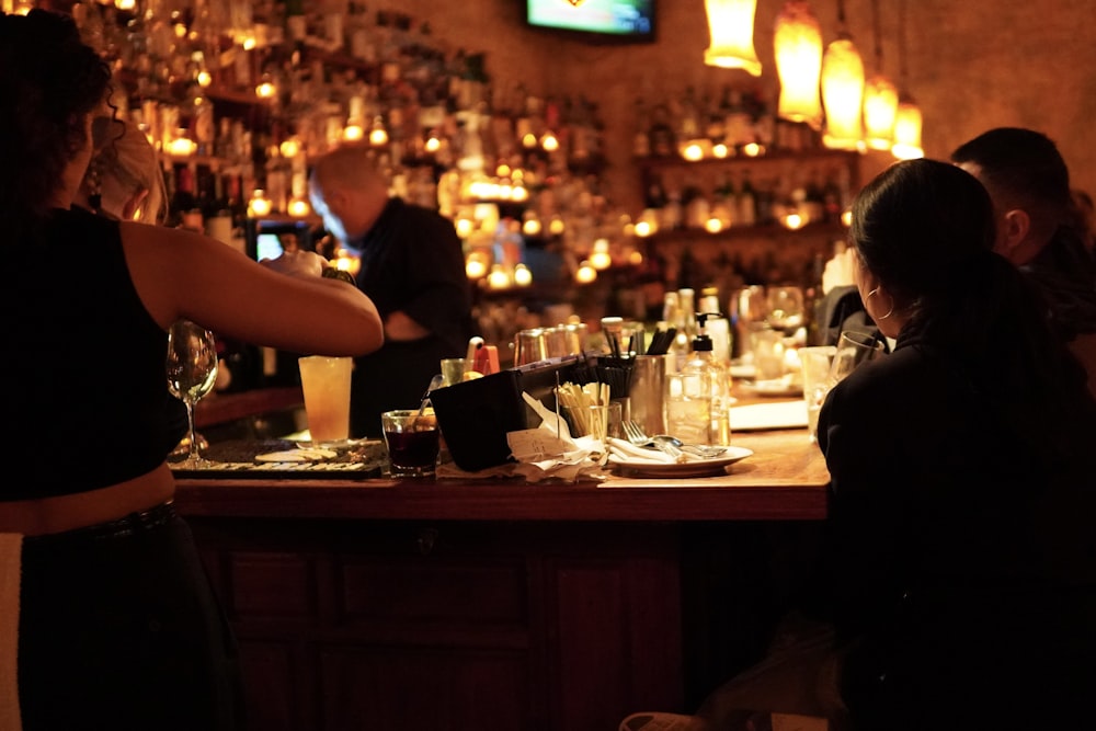 a group of people sitting at a bar