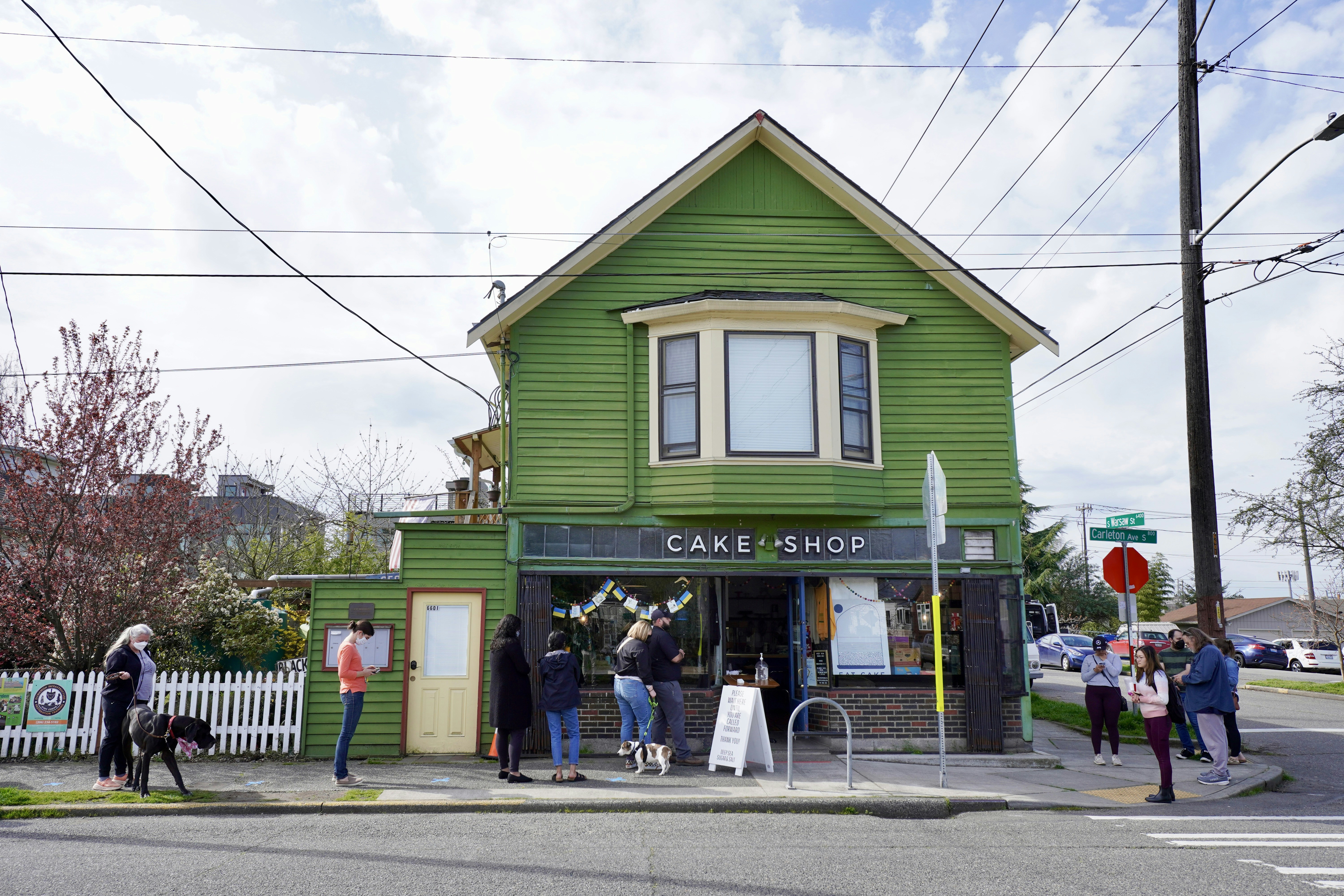a group of people outside a small building