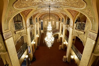 a large ornate hallway with chandeliers