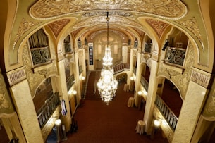 a large ornate hallway with chandeliers