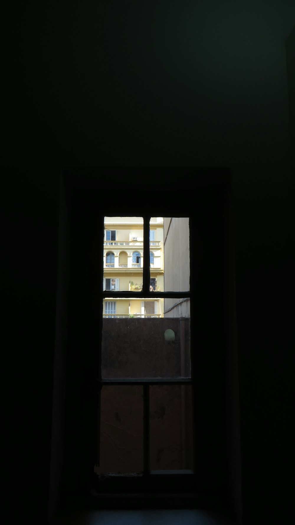 a window with a view of a building through it