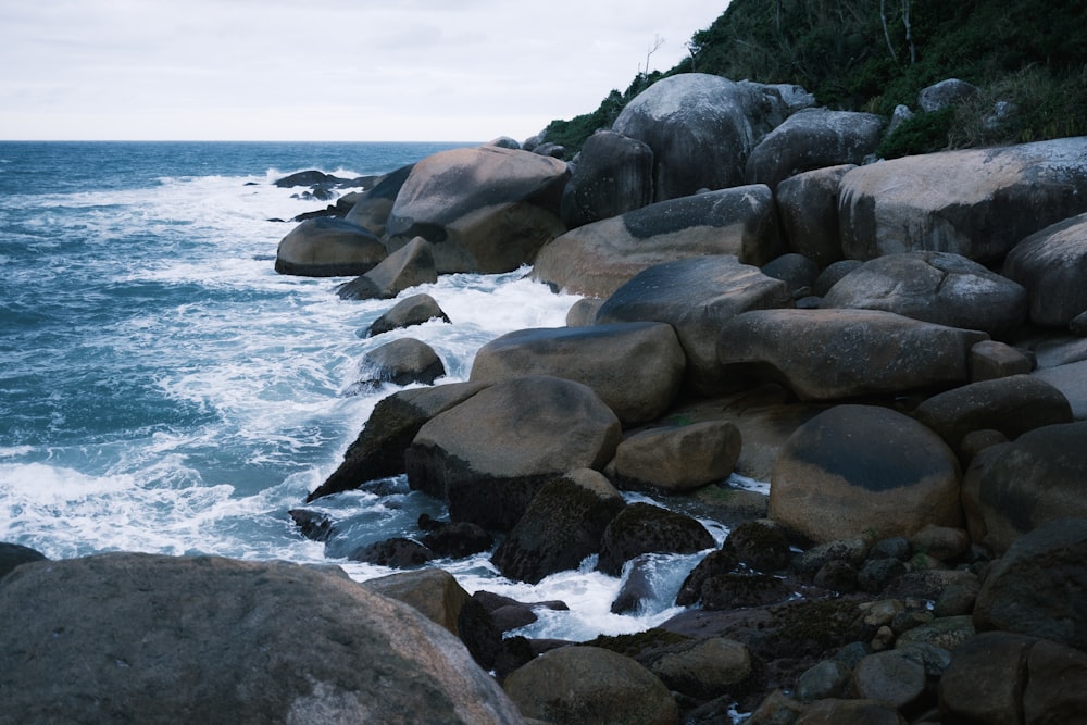 a rocky shoreline with waves crashing