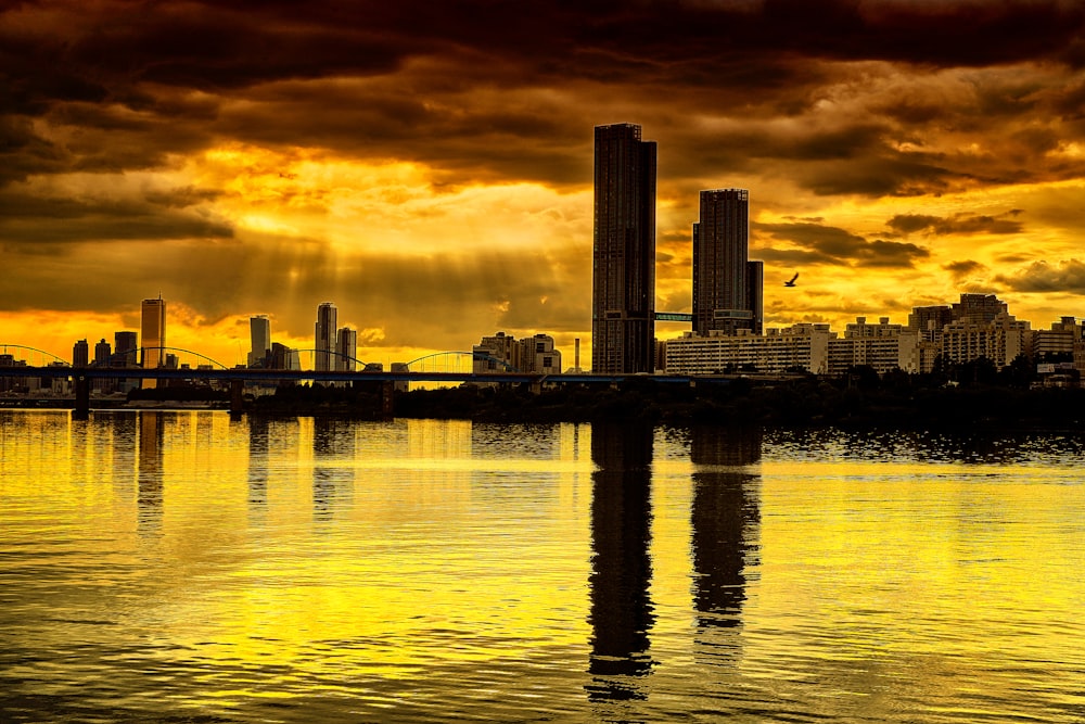 a city skyline with a body of water in front of it