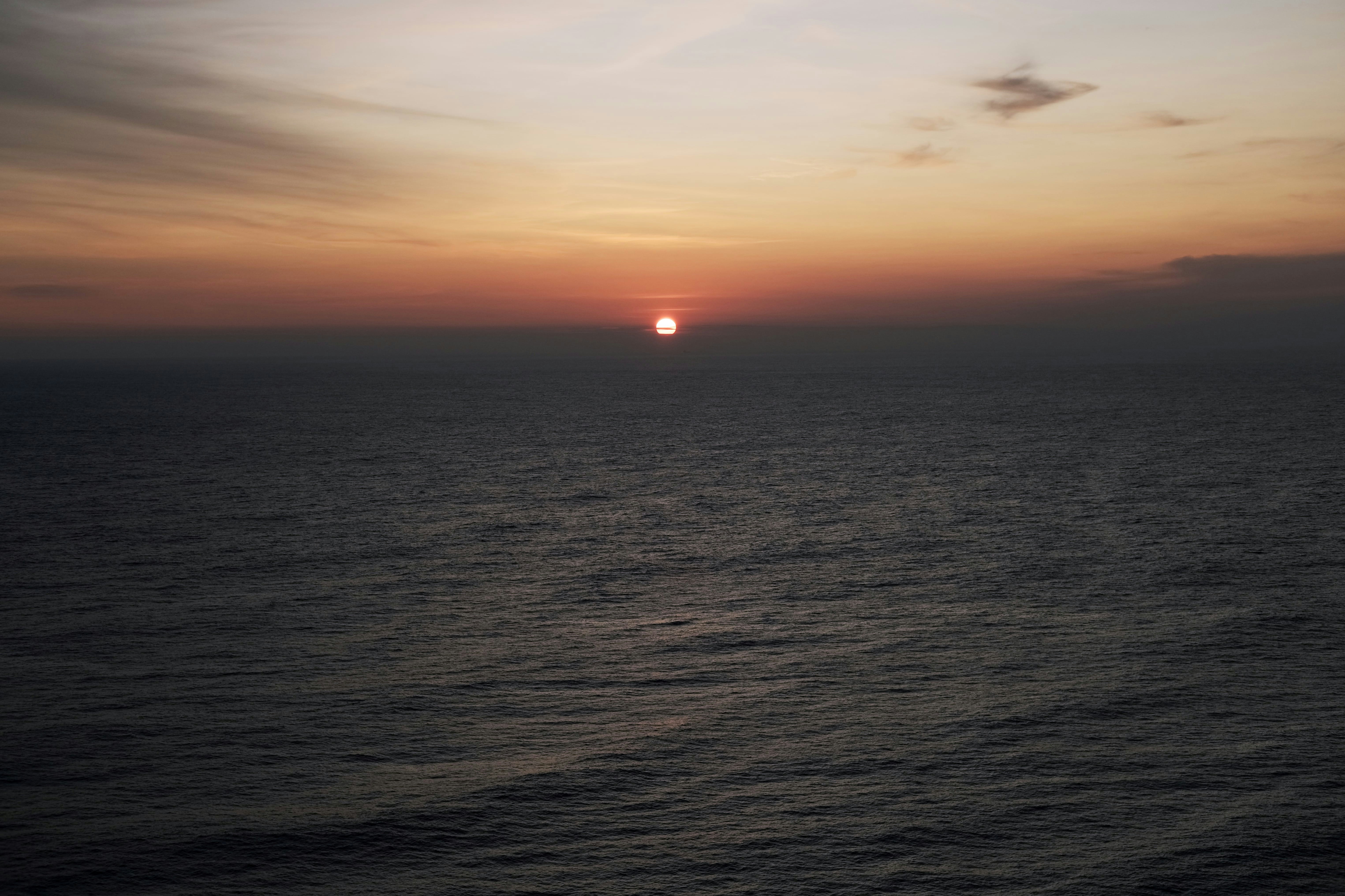 a sunset over a body of water