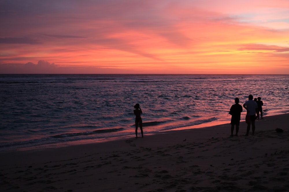 people standing on a beach