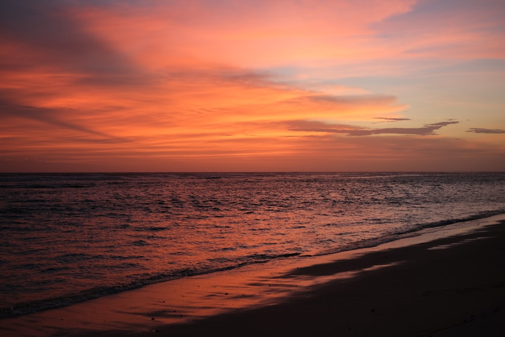 a beach with a sunset