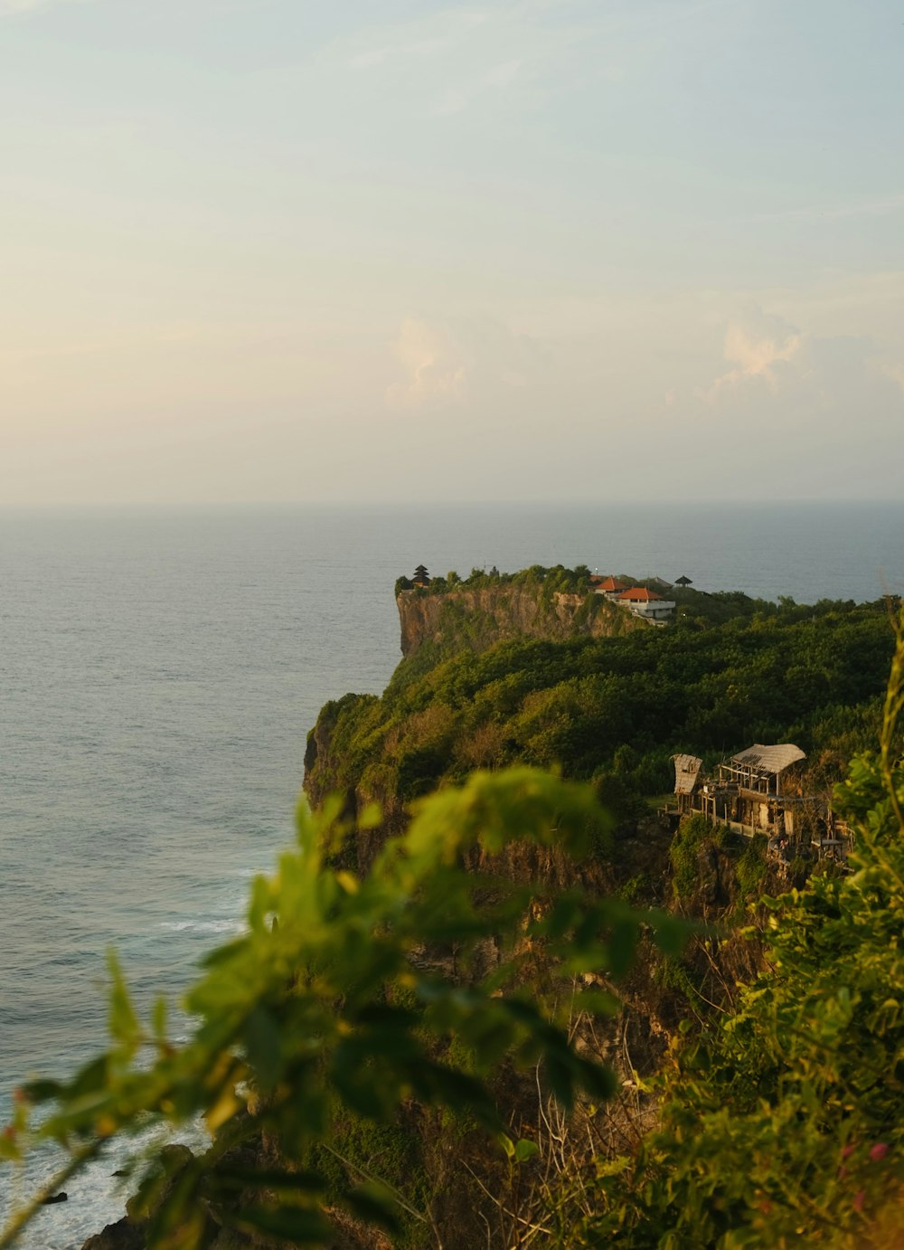 a building on a cliff by the water