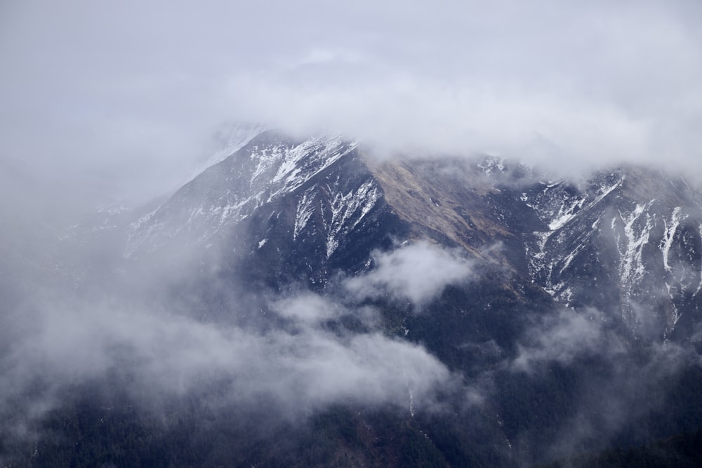 a mountain with clouds around it