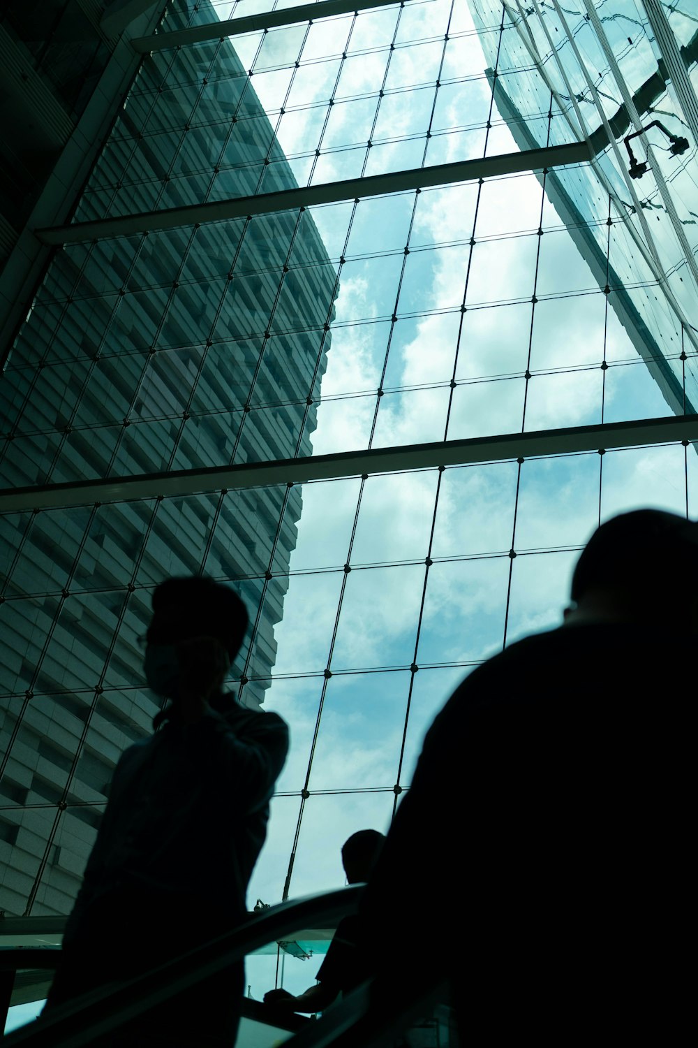 people looking through a glass ceiling