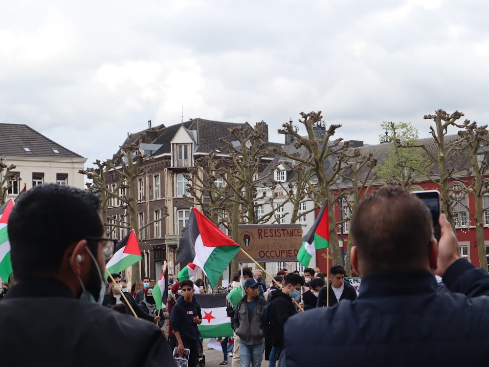 a group of people holding flags