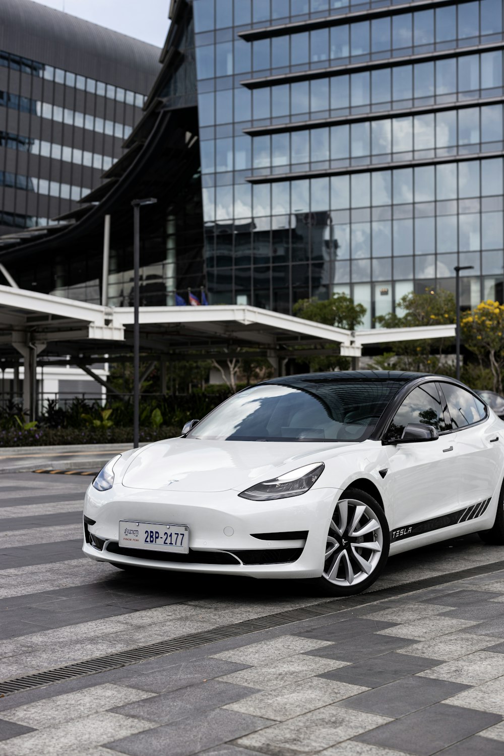 a white car parked in front of a building