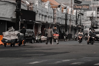 a group of people on motorcycles and scooters on a street
