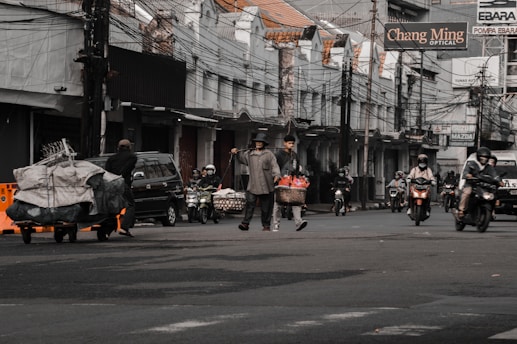 a group of people on motorcycles and scooters on a street