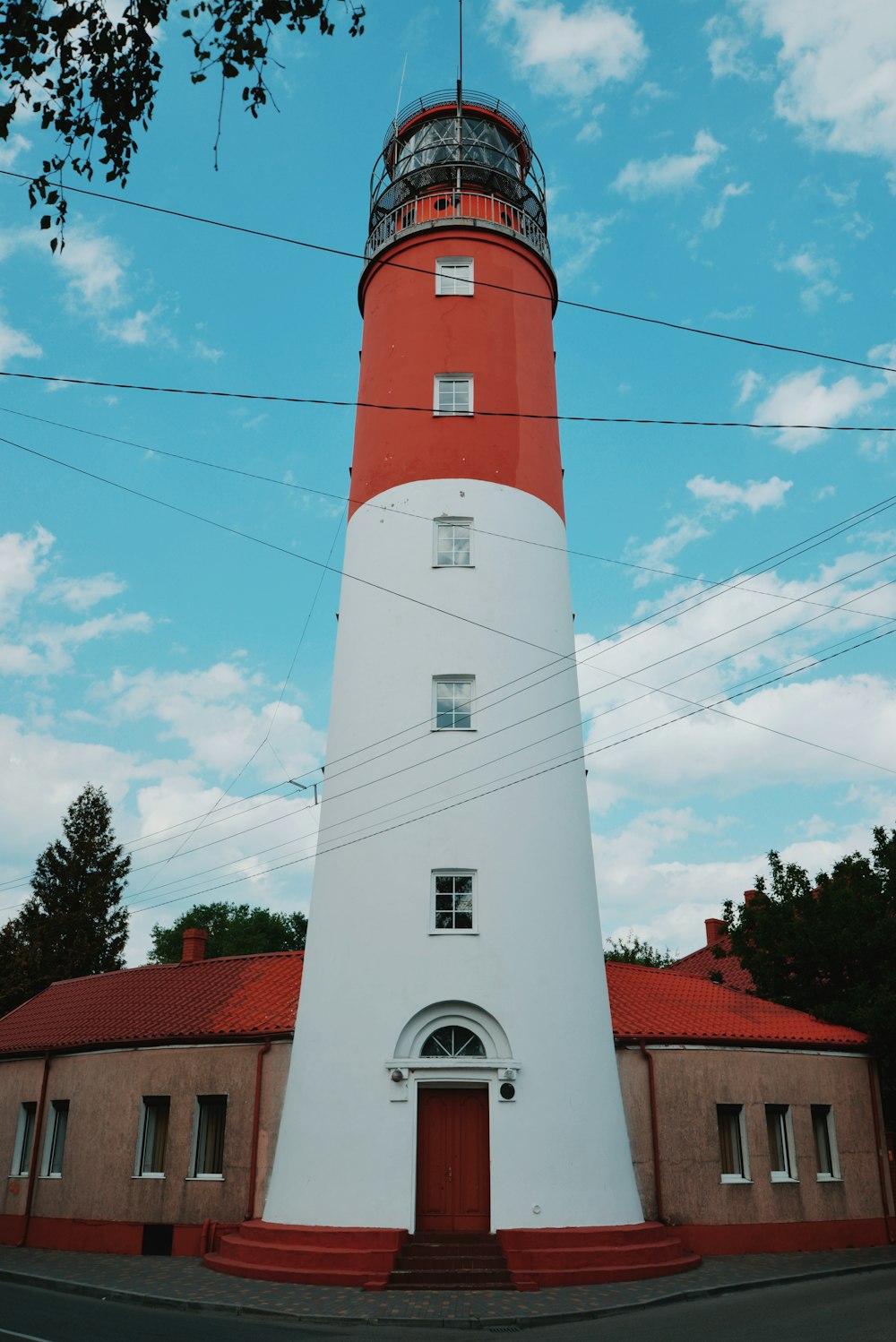 a lighthouse with a red and white tower