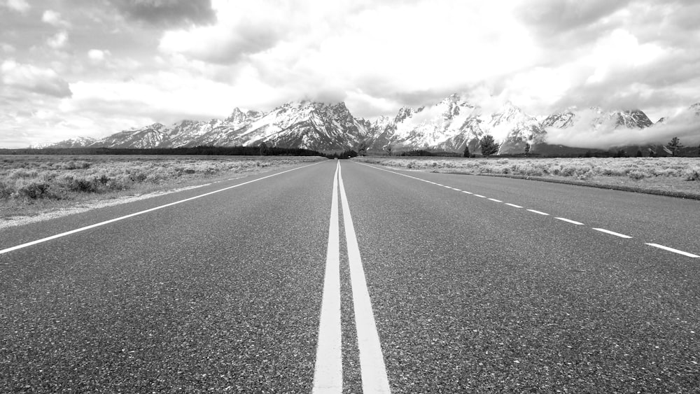 a road with mountains in the background