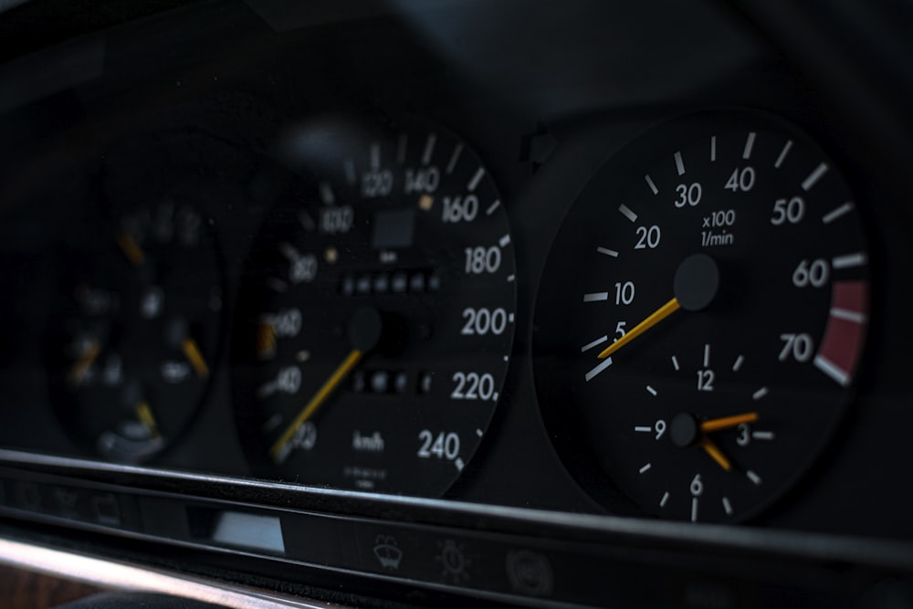 a car dashboard with black gauges