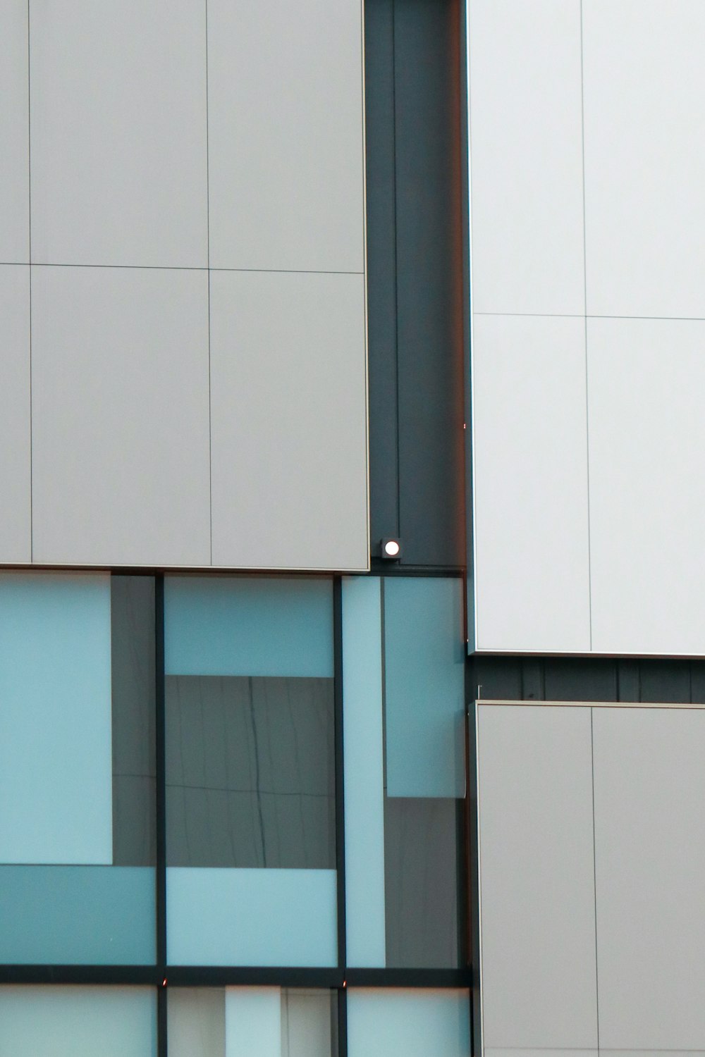 a white wall with a black door