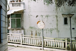 a white fence in front of a building