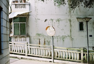 a white fence in front of a building