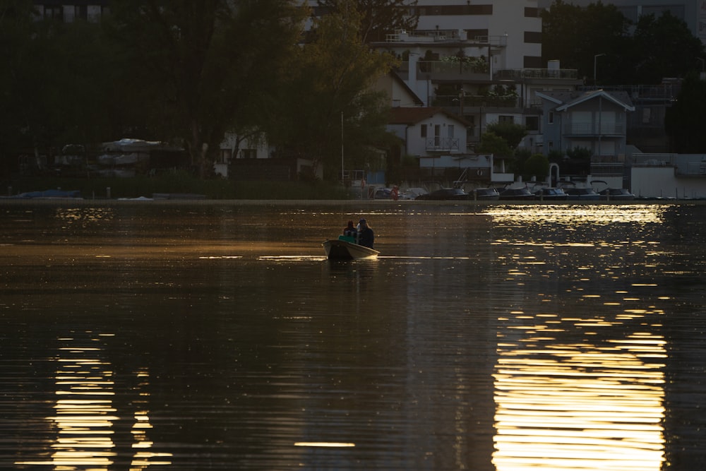 a couple people in a boat on a lake