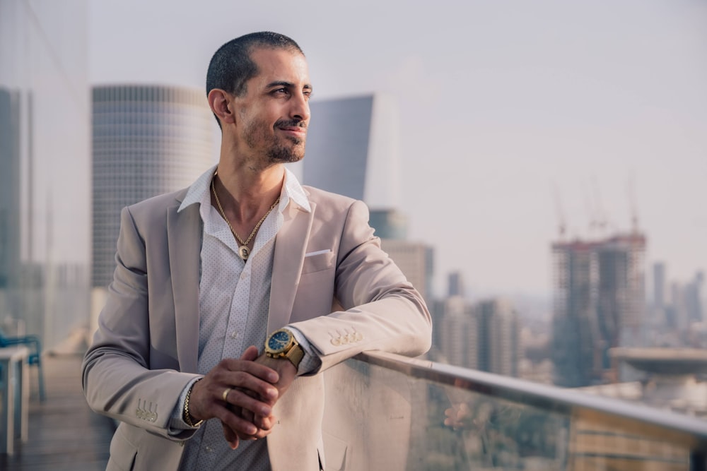 a man with a mustache and a beard standing on a balcony