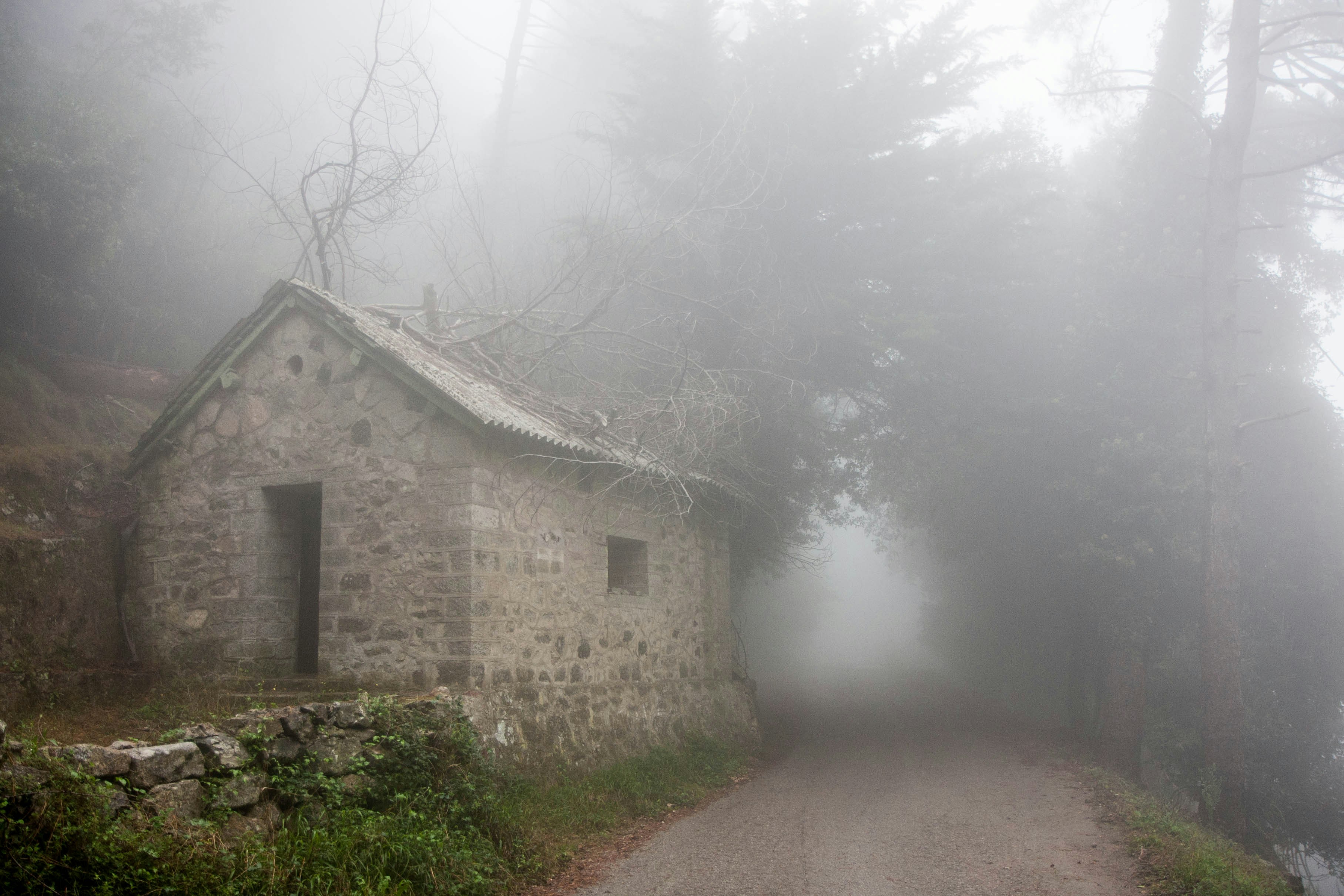 a stone building with a foggy sky