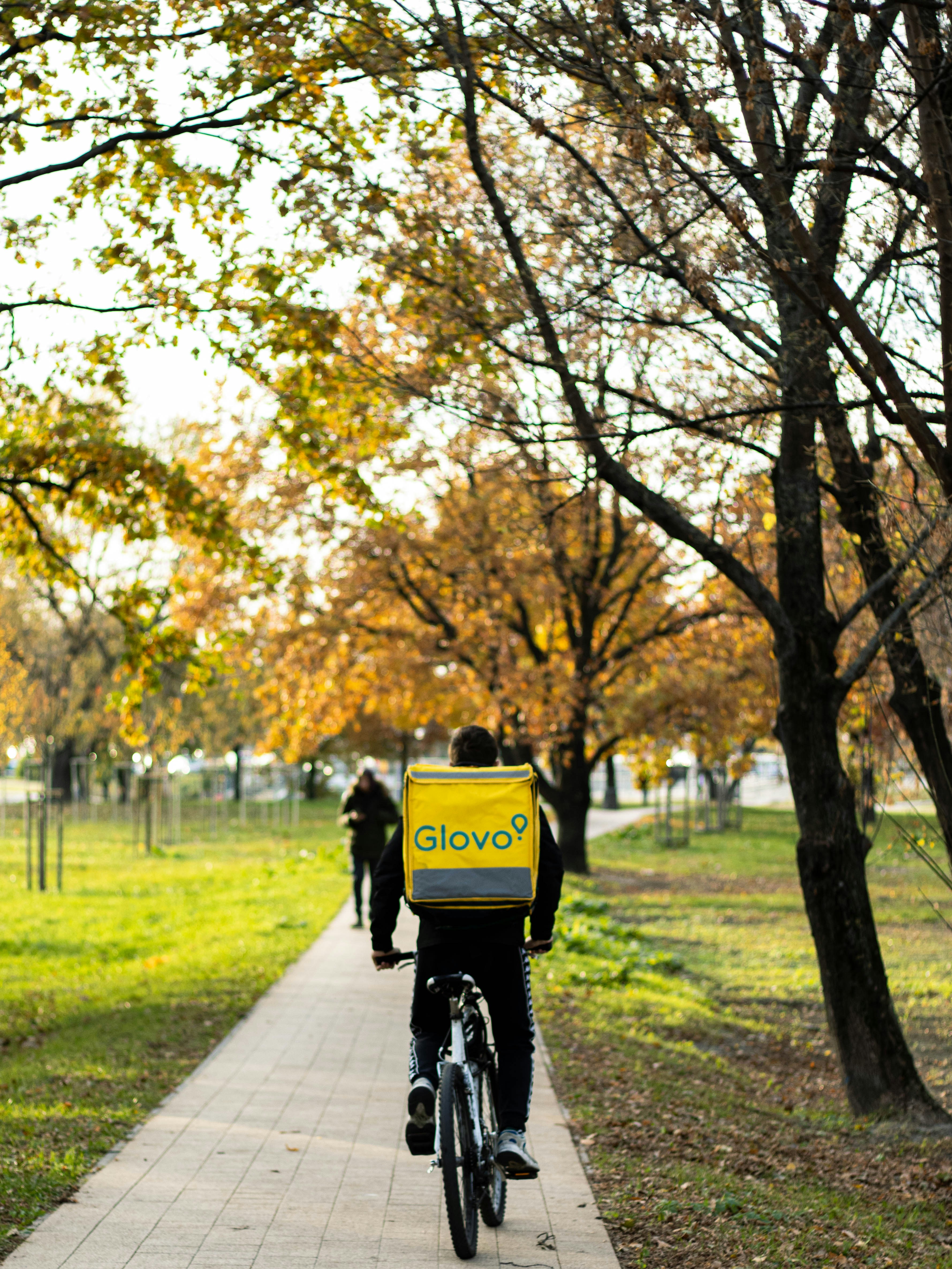 a Glovo courier riding a bicycle 