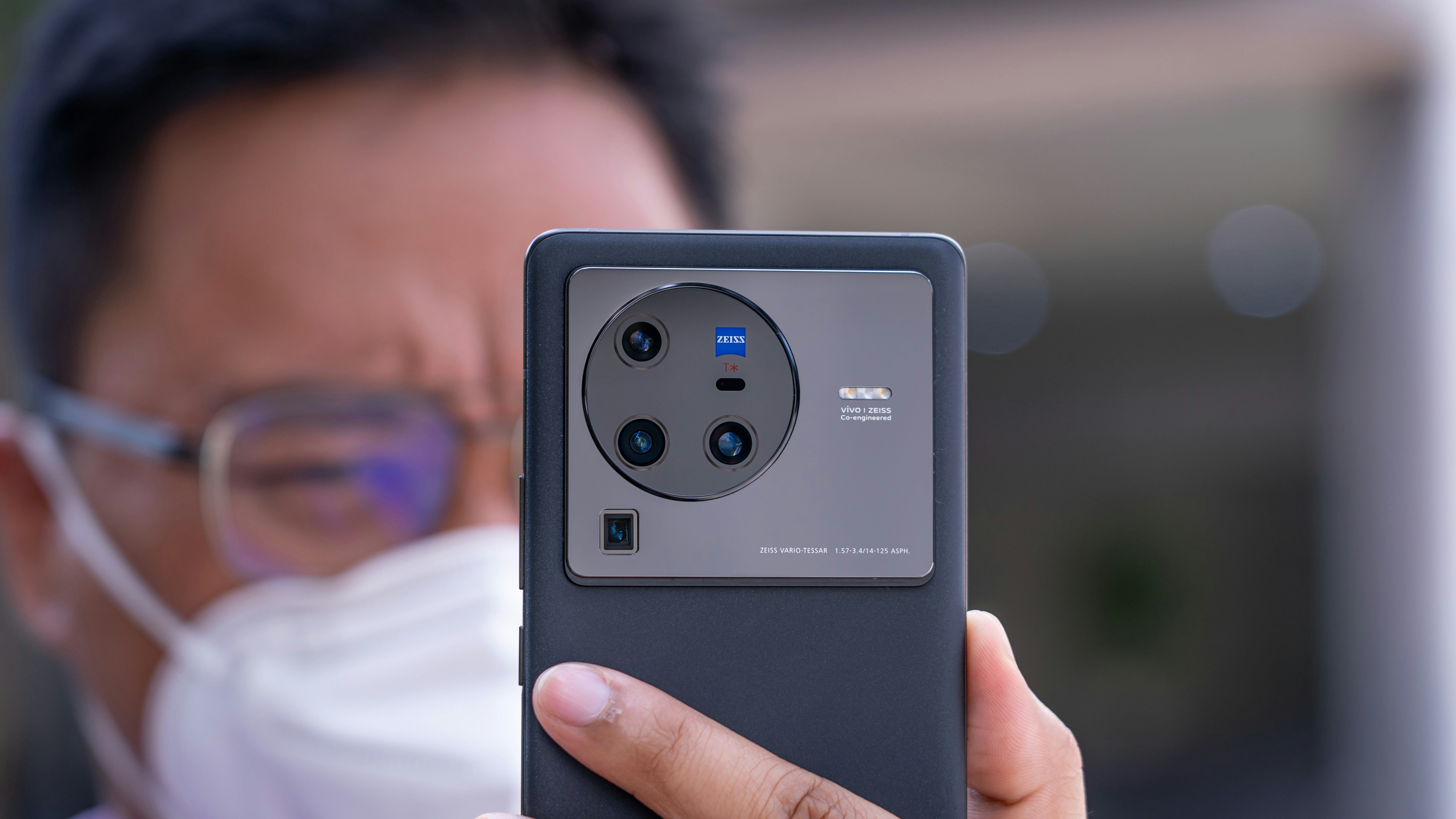 Technician holding a tablet that displays battery health data for a used electric car