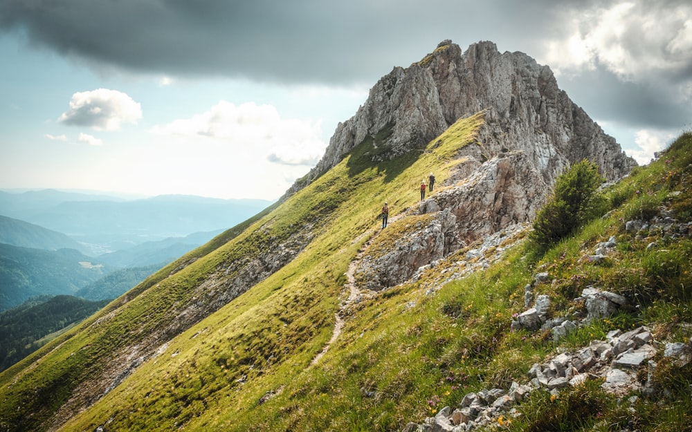 a group of people walking up a mountain