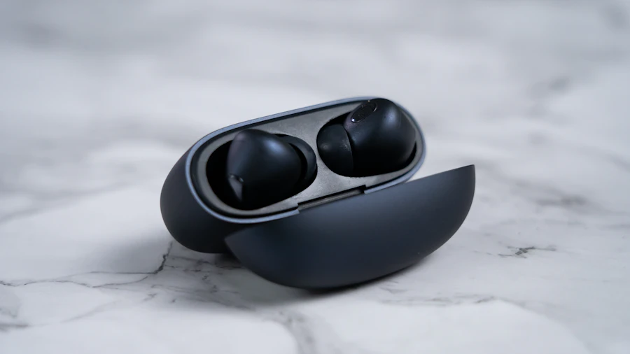 Vanta Buds 500 glossy black earbuds in an open case on a marble surface