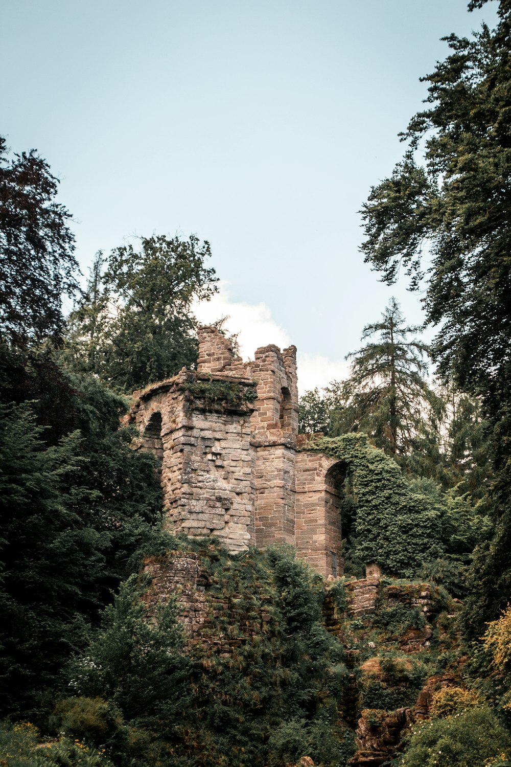 a stone structure surrounded by trees