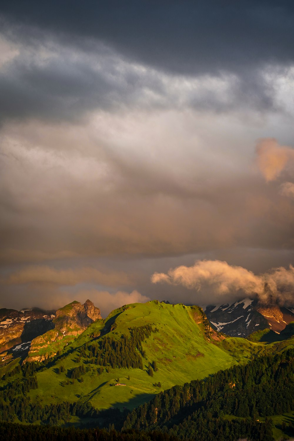 a mountain with clouds above it