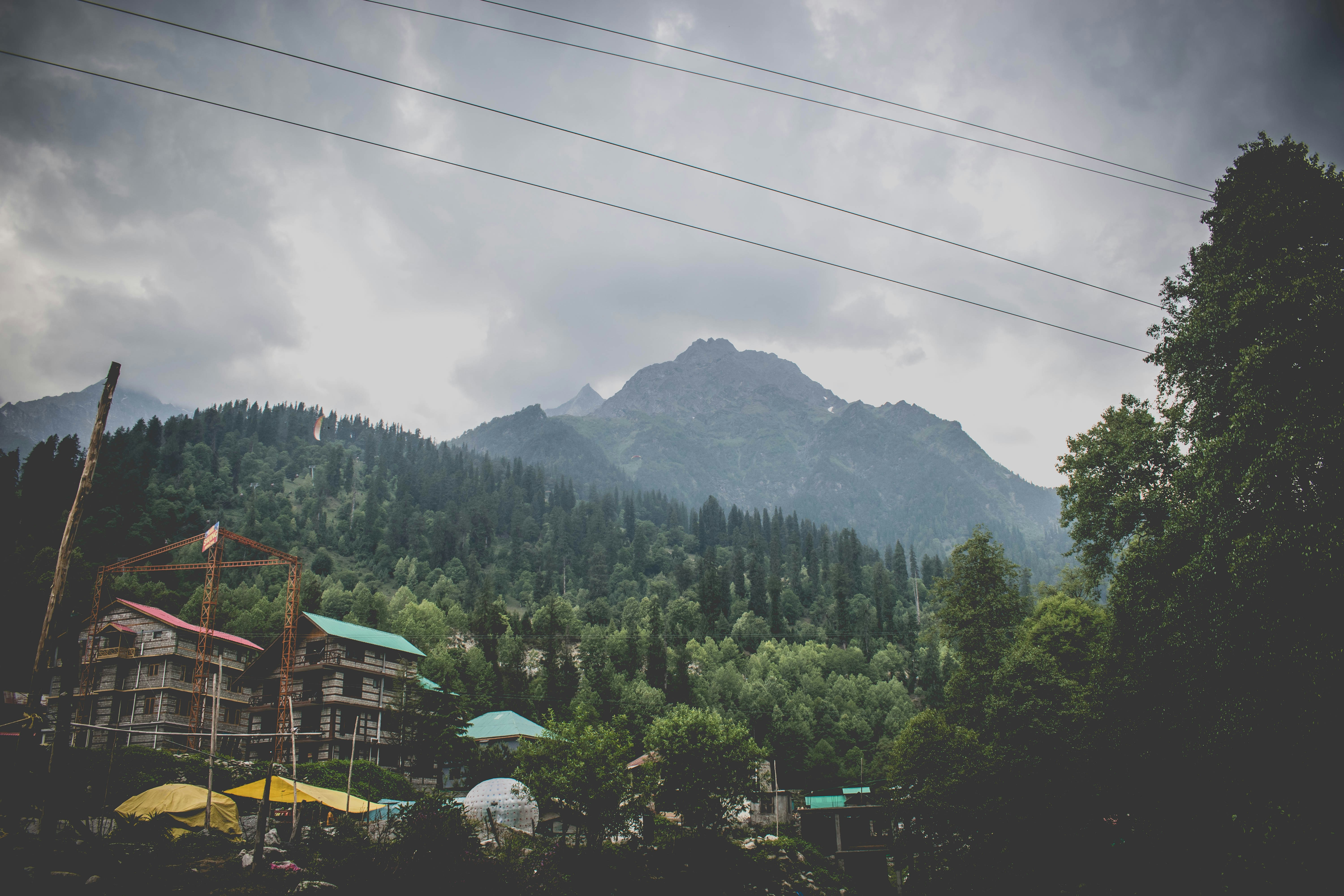 a building with trees and mountains in the background